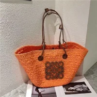 Orange Woven Rattan Tote Bag with Leather Handles and Decorative Metal Design