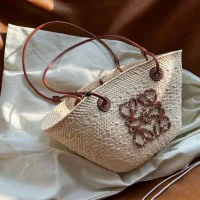 Woven Rattan Tote Bag with Brown Leather Handles and Decorative Metal Design