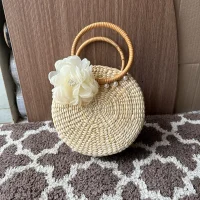 Round Rattan Handbag with Wooden Handles & White Flower Decor